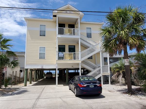 Three-story elevated beach home on engineered stilts