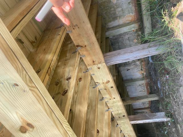 Metal connectors and hurricane ties fastening engineered wood framing members