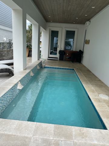 Covered patio with plunge pool and wood ceiling